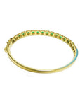 14K gold bangle bracelet with round brilliant cut bluish-green emeralds in square links with rope borders.