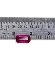 1.11 carat emerald cut natural ruby gemstone, deep red, displayed against a ruler.