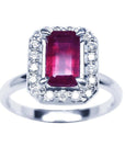 Emerald-cut ruby ring with diamond halo in 14K white gold.