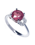 Round cut pinkish-red natural ruby ring with diamond accents set in 14k white gold.
