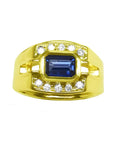 Men's sapphire ring east west emerald-cut bezel set 18k yellow gold, with a medium dark blue shade, bezel set in an east-west alignment.