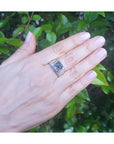 Men's 18K white gold ring with a bezel-set, emerald-cut 5.76 ct vivid blue sapphire.