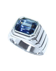 Blue sapphire ring for men emerald cut east west bezel set made of 18K white gold.