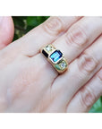 Men's 14K yellow gold ring with emerald cut blue sapphire and two round side diamonds.