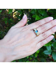 Men's 14K yellow gold ring with emerald cut blue sapphire and two round side diamonds.