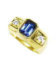 Men's 14K yellow gold ring with an emerald cut blue sapphire and two round side diamonds.