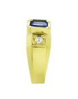 Men's 14K yellow gold ring with an emerald cut blue sapphire and round side diamond.