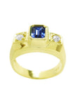 Men's 14K yellow gold ring with emerald cut blue sapphire and two round side diamonds.