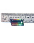 A Brazilian watermelon tourmaline next to a ruler on a white background.