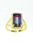 14K gold ring with a rectangular 5.60 ct. green and pink watermelon tourmaline, surrounded by diamonds.