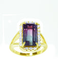 A natural watermelon tourmaline ring with a halo diamond, crafted in 14k yellow gold, from the top-down profile view.