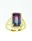 A natural watermelon tourmaline ring with a halo diamond, crafted in 14k yellow gold, from the top-down profile view.