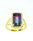 14K gold ring with a rectangular 5.60 ct. green and pink watermelon tourmaline, surrounded by diamonds.