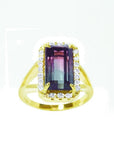 14K gold ring with a rectangular 5.60 ct. green and pink watermelon tourmaline, surrounded by diamonds.