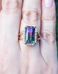 Women's 14K gold ring with a rectangular 5.60 ct. green and pink watermelon tourmaline, surrounded by diamonds.