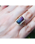 Watermelon tourmaline ring with green and pink rectangular gemstone, surrounded by diamonds on a 14K gold band.