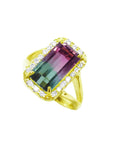 A natural watermelon tourmaline ring with a halo diamond, crafted in 14k yellow gold, tilted left side position top view.