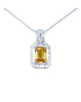 Emerald cut yellow sapphire pendant with halo diamonds on an 18K white gold chain.