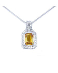 Emerald cut yellow sapphire pendant with halo diamonds on an 18K white gold chain.