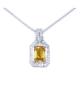 Emerald cut yellow sapphire pendant with halo diamonds on an 18K white gold chain.