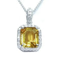 Natural yellow sapphire pendant showcasing a vibrant medium-light hue halo diamonds handcrafted in 18k white gold.