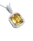 Right side, top view of a natural yellow sapphire pendant halo diamonds handcrafted in 18k white gold