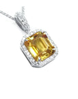 Natural yellow sapphire pendant halo diamonds handcrafted in 18k white gold.