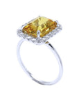 Emerald cut 4.59 ct yellow sapphire ring with diamond halo in 14K white gold.