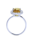 Emerald cut 4.59 ct yellow sapphire ring with diamond halo in 14K white gold.