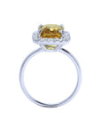 Emerald cut 4.59 ct yellow sapphire ring with diamond halo in 14K white gold.