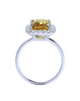 Emerald cut 4.59 ct yellow sapphire ring with diamond halo in 14K white gold.