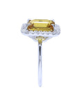 Emerald cut yellow sapphire ring with diamond halo in 14K white gold.