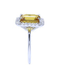 Emerald cut yellow sapphire ring with diamond halo in 14K white gold.