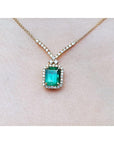 Emerald necklace with halo natural diamonds on a 14K yellow gold chain.
