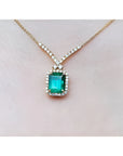 Emerald necklace with halo natural diamonds on a 14K yellow gold chain.