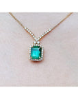 Emerald necklace with halo natural diamonds on a 14K yellow gold chain.