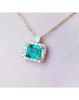 1.31 ct emerald-cut Muzo Colombian emerald necklace with diamonds in 14K yellow gold.
