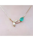 1.66 carat pear-cut natural emerald necklace in 14K yellow gold with diamond-accented twig design.