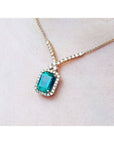 Emerald-cut Emerald necklaces Muzo Colombia natural deep green bluish color, encircled by a halo diamond