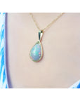 Pear-shaped Ethiopian Welo opal pendant in 14K yellow gold, showing fire red-orange and rainbow colors.