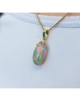 Ethiopian Welo opal pendant with red fire, set in 14k yellow gold on a chain.