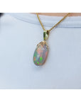 Ethiopian Welo opal pendant with red fire, set in 14k yellow gold on a chain.