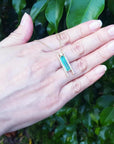 Emerald baguette cut necklace with natural diamonds and 14K yellow gold sliding tube bail.