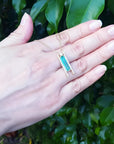 Emerald baguette cut necklace with natural diamonds and 14K yellow gold sliding tube bail.