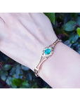 Women's 14K yellow gold bracelet with a central oval-cut natural emerald and sparkling green color.