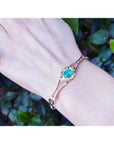 Women's 14K yellow gold bracelet with a central oval-cut natural emerald and sparkling green color.