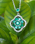14K white gold cluster necklace with natural Colombian emeralds and diamond 4-leaf clover design on green leaves.