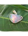 9.30 ct. Ethiopian opal necklace pendant in 14K yellow gold, showcasing red and orange fire.