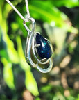4.30 ct teardrop Ethiopian black opal pendant in sterling silver with multicolor flashes.