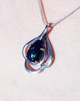 4.30 ct teardrop Ethiopian black opal pendant in sterling silver with multicolor flashes.